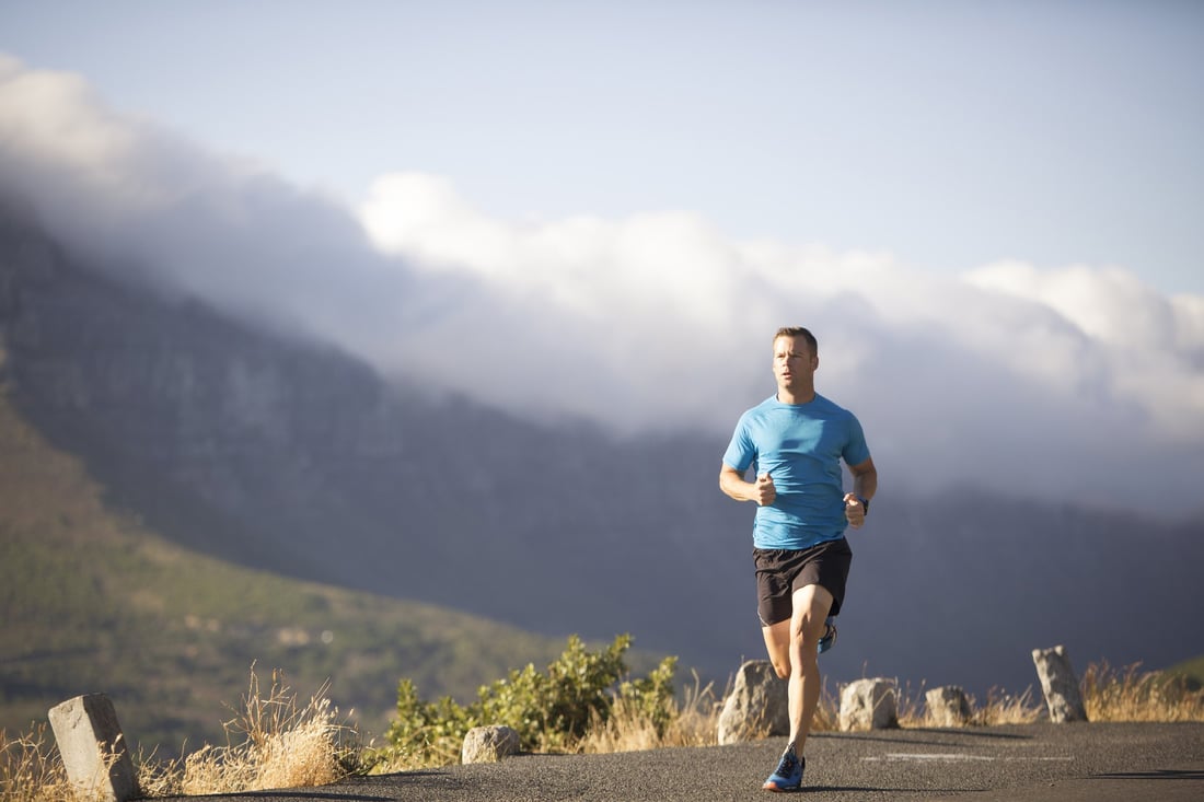 A man running along a mountain road